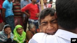 A Bangladeshi boy cries for his mother, missing after a ferry they were travelling in capsized in the River Padma in Munshiganj district, Aug. 5, 2014.