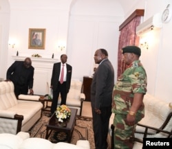 FILE - Mugabe meets with Father Fidelis Mukonori, Secretary to the Cabinet Dr Misheck Sibanda and Defense Forces Commander General Constantino Chiwenga at State House in Harare, Nov. 19, 2017.