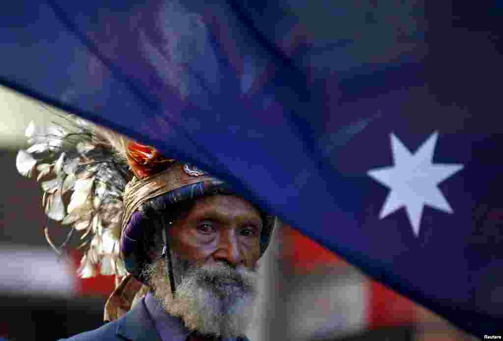 A veteran from Papua New Guinea wears a traditional head dress as he marches during the ANZAC (Australian and New Zealand Army Corp) Day march through central Sydney, Australia.