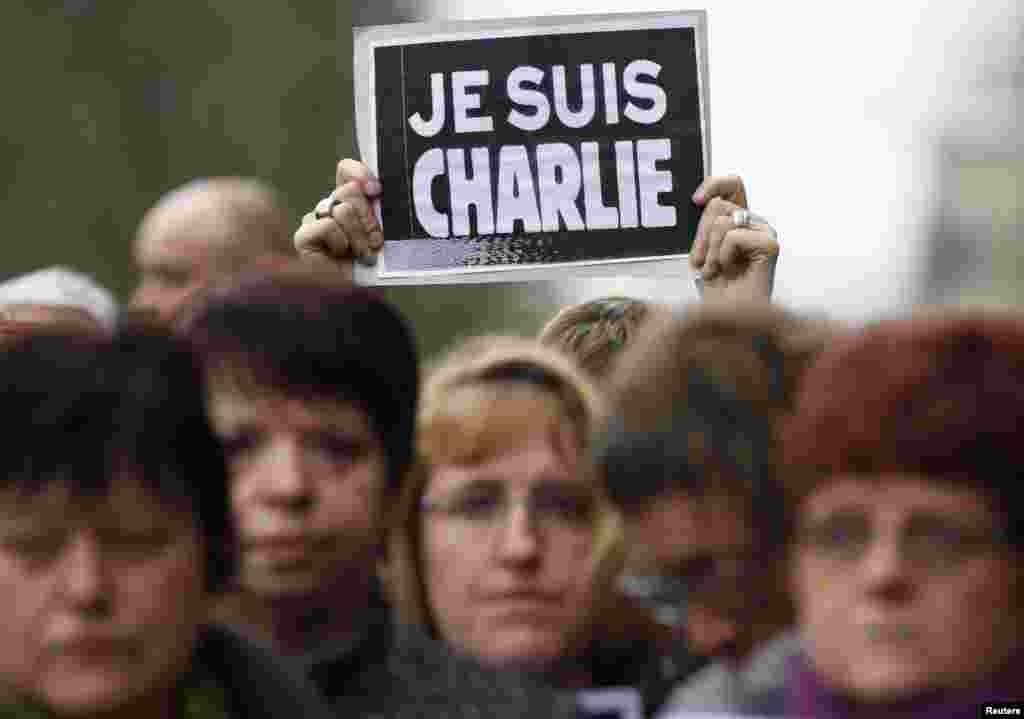 A woman holds a placard which reads "I am Charlie" during a minute of silence for victims of the shooting at Charlie Hebdo, in Strasbourg, Jan. 8, 2015.