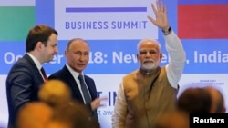 FILE - India's Prime Minister Narendra Modi waves as Russian President Vladimir Putin looks on after attending the India-Russia Business Summit in New Delhi, India, Oct. 5, 2018. 