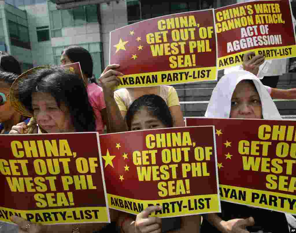 Protesters picket the Chinese Consulate at the financial district of Makati city, east of Manila, Philippines, to protest the recent use of water cannons by Chinese coast guard to drive away Filipino fishermen off the disputed Scarborough Shoal in the South China Sea.