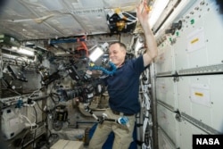 NASA astronaut Ricky Arnold does some filming on the International Space Station Oct. 3, 2018