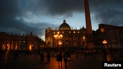 People walk in Saint Peter's Square at the Vatican, March 7, 2013.