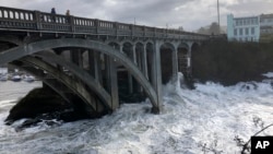 In this Jan. 11, 2020 photo heavy surf surrounds the legs of a bridge as an extreme high tide rolls into the harbor in Depoe Bay, Ore. during a so-called "king tide" that coincided with a big winter storm. (AP)