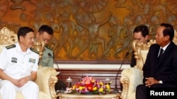 Captain Wang Hong Li (L), Commanding Officer of the 23rd Chinese Naval Escort Task Force, smiles as Cambodia's Defense Minister Tea Banh (R) speaks during a meeting at the Ministry of National Defense of Cambodia, in Phnom Penh, Cambodia October 17, 2016.