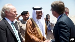 U.S. Defense Secretary Ash Carter, right, is greeted by Saudi Arabian Assistant Minister of Defense Mohammad Al-Ayesh, center, as Tim Lenderking U.S. Embassy Deputy Chief of Mission stands left, after his arrival in Jiddah, Saudi Arabia, July 22, 2015.