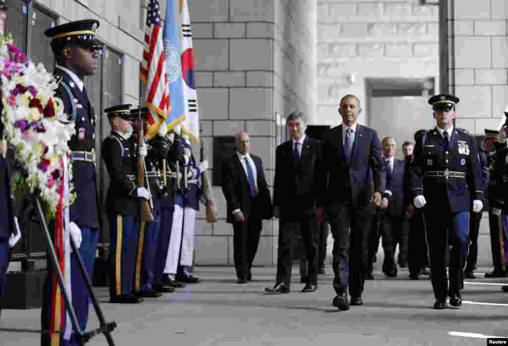 President Barack Obama walks up to participate in a wreath laying ceremony at the National War Memorial in Seoul, April 25, 2014.