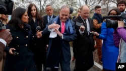 White House chief economic adviser Larry Kudlow calls for a "timeout" as he talks to reporters outside the White House, April 6, 2018, in Washington. 