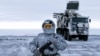 In this photo taken on April 3, 2019, a Russian solder stands guard near a Pansyr-S1 air defense system on the Kotelny Island, part of the New Siberian Islands archipelago located between the Laptev Sea and the East Siberian Sea, Russia. 