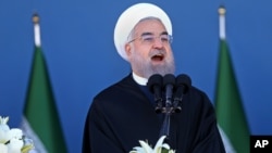 Iran's President Hassan Rouhani speaks at a military parade marking National Army Day in front of the mausoleum of the late revolutionary founder Ayatollah Khomeini, just outside Tehran, April 17, 2016.