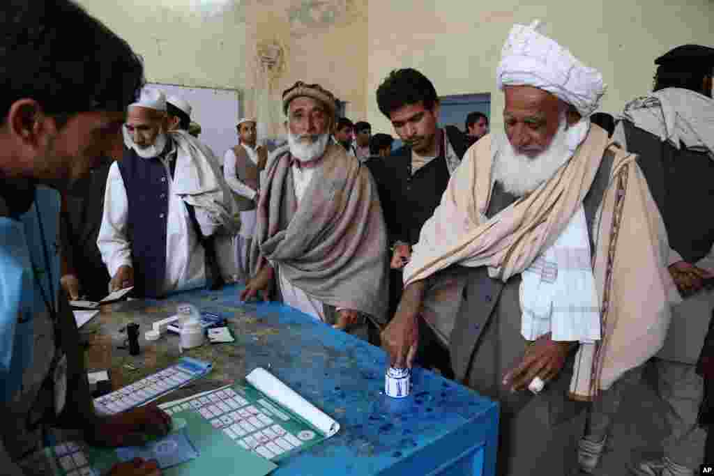 An Afghan man dips his finger into ink before casting a vote at a polling station in Jalalabad, east of Kabul.