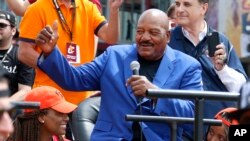 FILE - Cleveland Browns Hall of Fame running back Jim Brown rides in the parade celebrating the Cleveland Cavaliers' NBA Championship in downtown Cleveland, June 22, 2016. Brown and 21 other Pro Football Hall of Famers sent a letter to the NFL demanding health insurance coverage and an annual salary.