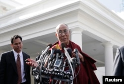 FILE - The Tibetan spiritual leader the Dalai Lama talks to the media after his meeting with U.S. President Barack Obama at the White House in Washington, Feb. 18, 2010.