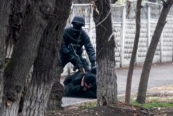 An armed riot police officer detains a protester after clashes in Almaty, Kazakhstan, Jan. 8, 2022.
