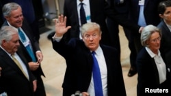 U.S. President Donald Trump waves as he arrives for the World Economic Forum (WEF) annual meeting in Davos, Switzerland 