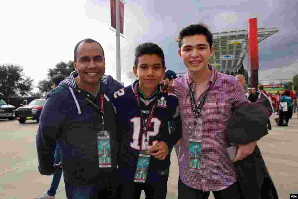 Fans proudly display their tickets to the Super Bowl -- where the cheapest "get-in" ticket will go for around $2,000. (B. Allen/VOA)