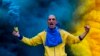 An Estoril Praia soccer team fan cheers for his team in the beginning of a Portuguese First League Soccer match at António Coimbra da Mota Stadium, Estoril, Portugal.