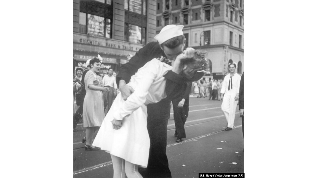 FILE - In a photo provided by the U.S. Navy, a sailor and a woman kiss in New York's Times Square, as people celebrate the end of World War II, Aug. 14, 1945. George Mendonsa was the young sailor in the photo.