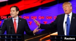 FILE - Republican U.S. presidential candidates Marco Rubio (L) and Donald Trump speak simultaneously at the debate sponsored by CNN for the 2016 Republican U.S. presidential candidates in Houston, Texas, Feb. 25, 2016.