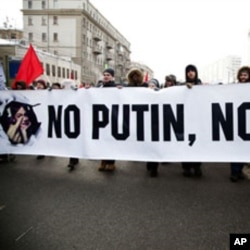 Protesters walk with anti-Putin banner in mass opposition march in central Moscow, February 4, 2012.
