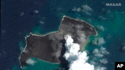 FILE - This satellite image provided by Maxar Technologies shows an overview of Hunga Tonga Hunga Ha'apai volcano in Tonga on Jan. 6, 2022, before a huge undersea volcanic eruption.