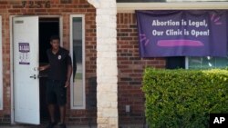 A security guard opens the door to the Whole Women's Health Clinic in Fort Worth, Texas, Wednesday, Sept. 1, 2021. A divided United States Supreme Court refused to block a Texas law that activists say effectively bans abortions in the nation’s second-larg