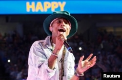 Pharrell Williams performs his hit song "Happy" at the Walmart annual shareholders meeting in Fayetteville, Arkansas, June 6, 2014.