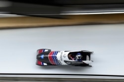 Elana Meyers Taylor of the U.S. competes in the women's monobob during the IBSF Bobsleigh International Sanctioned Race, part of a 2022 Beijing Winter Olympic Games test event, at the Yanqing National Sliding Center in Beijing, Oct. 25, 2021.