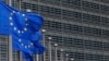 FILE - European Union flags set of half staff outside the European Commission headquarters in Brussels, Belgium.