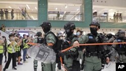 Riot police enter the shopping mall to disperse the protesters during the Labor Day in Hong Kong, May 1, 2020.