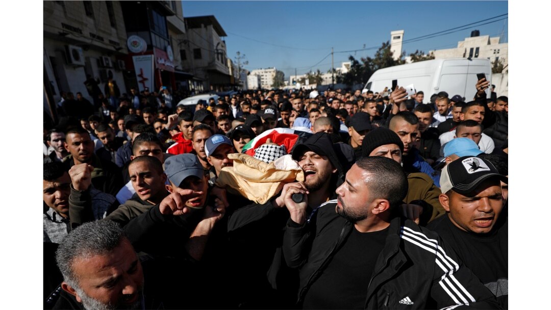 Mourners carry the body of Palestinian Yazan Abu Tabekh, who was killed during an Israeli raid, during his funeral in Jenin in the Israeli-occupied West Bank, Feb. 6, 2020.