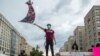 Protester waves U.S. flag with "Black Lives Matter" spray painted on it, Washington, DC, June 19, 2020.