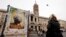 A woman looks at a poster supporting Cardinal Peter Turkson in front of the Papal Basilica of Saint Mary in Rome, March 1, 2013. 