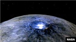 FILE - This representation of Ceres' Occator Crater in false colors shows differences in the surface composition.