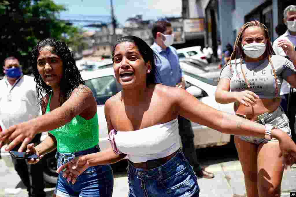 People with hospitalized relatives watch firefighters battle a blaze at the Bonsucesso Federal Hospital in Rio de Janeiro, Brazil. According to the fire department, there were no casualties.