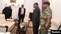FILE - Zimbabwe's President Robert Mugabe meets with Father Fidelis Mukonori, Secretary to the Cabinet Dr Misheck Sibanda and Defense Forces Commander General Constantino Chiwenga at State House in Harare, Nov. 19, 2017. 