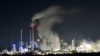A Uniper coal-fired power plant and a BP oil refinery and chemical plant are at work in Gelsenkirchen, Germany, on Wednesday evening, Dec. 4, 2019.