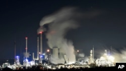 A Uniper coal-fired power plant and a BP oil refinery and chemical plant are at work in Gelsenkirchen, Germany, on Wednesday evening, Dec. 4, 2019.