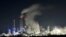 A Uniper coal-fired power plant and a BP oil refinery and chemical plant are at work in Gelsenkirchen, Germany, on Wednesday evening, Dec. 4, 2019.