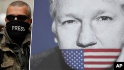 Un partidario de Julian Assange, con un póster del fundador de WikiLeaks, se une a otros manifestantes para bloquear una carretera principal frente al Tribunal de Magistrados de Westminster en Londres, el jueves 2 de mayo.