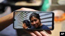 Un familiar muestra en un celular una foto de Juana Guadalupe Recinos, que fue detenida el año pasado durante la guerra del gobierno contra las pandillas, en Santa Ana, El Salvador, el 31 de enero de 2024. 