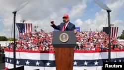 Trump gestures as he speaks during a campaign rally outside Raymond James Stadium, in Tampa