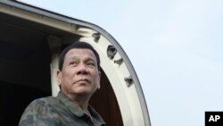 In this July 15, 2019, photo released by the Malacanang Presidential Photo, Philippine President Rodrigo Duterte arrives at the Jolo airport, Sulu province, southern Philippines. 