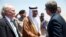 U.S. Defense Secretary Ash Carter, right, is greeted by Saudi Arabian Assistant Minister of Defense Mohammad Al-Ayesh, center, as Tim Lenderking U.S. Embassy Deputy Chief of Mission stands left, after his arrival in Jiddah, Saudi Arabia, July 22, 2015.