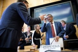 World Health Organization (WHO) director-general Tedros Adhanom Ghebreyesus (R) listens to a delegate at the end of a meeting organised the United Nations on the Ebola disease in DRC, on July 15, 2019, in Geneva.