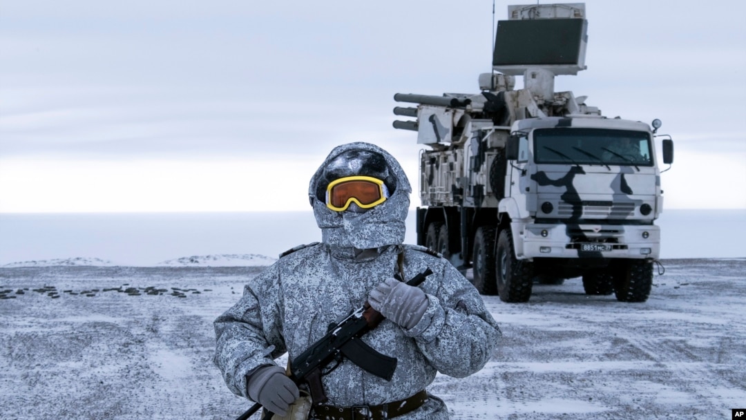 In this photo taken on April 3, 2019, a Russian solder stands guard near a Pansyr-S1 air defense system on the Kotelny Island, part of the New Siberian Islands archipelago located between the Laptev Sea and the East Siberian Sea, Russia. 