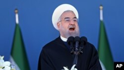 Iran's President Hassan Rouhani speaks at a military parade marking National Army Day in front of the mausoleum of the late revolutionary founder Ayatollah Khomeini, just outside Tehran, April 17, 2016.