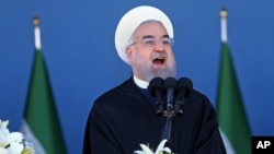 Iran's President Hassan Rouhani speaks at a military parade marking National Army Day in front of the mausoleum of the late revolutionary founder Ayatollah Khomeini, just outside Tehran, April 17, 2016.