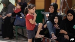 Displaced people sit at a vocational training center run by the U.N. agency for Palestinian refugees, or UNRWA, in the southern town of Sebline, south of Beirut, Oct. 4, 2024.